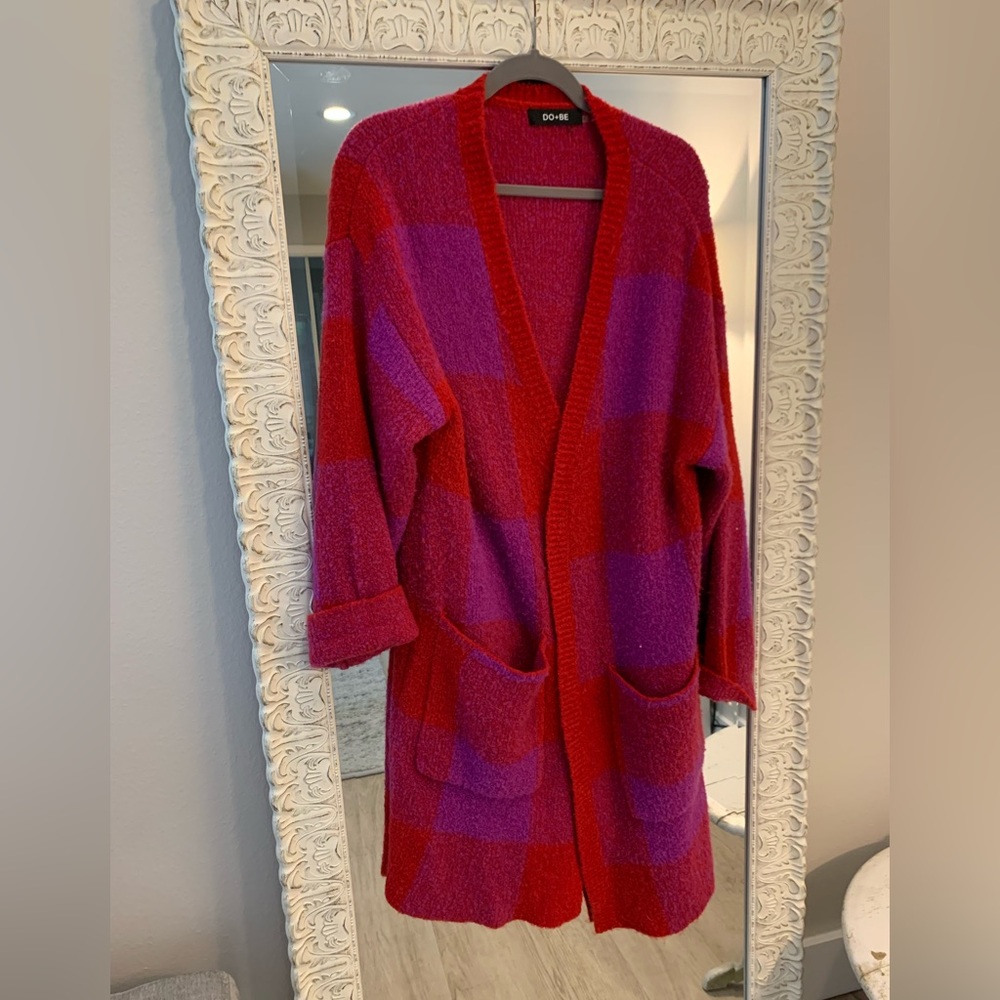 Fun oversized sweater in brilliant red and purple. No buttons.